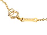 a close up of a gold plated necklace with a key on it