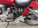 a red motorcycle that is parked on the side of the road