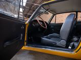 a yellow car that is parked in a garage