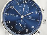a close up of a wrist watch with a blue dial