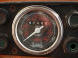 a close up of a clock on the dashboard of a car