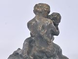 a statue of a man holding a child on a rock