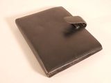 wallet with a leather strap on it on a white surface