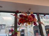 a vase filled with flowers sitting in front of a window
