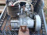 a small engine sitting in a basket on the ground