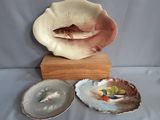 three plates that are sitting on a wooden stand