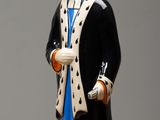 a figurine of a man with a hat and coat