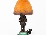 a lamp that has a horse on it and a dog on the base