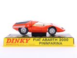 a red toy car sitting on top of a box