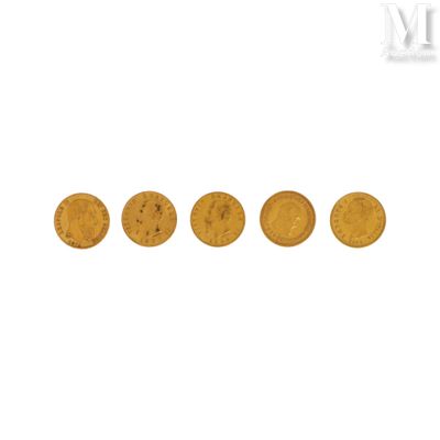 a group of five gold coins sitting on top of a white surface
