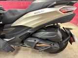 a silver and gold motorcycle parked in a garage