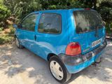 a small blue car parked on the side of the road