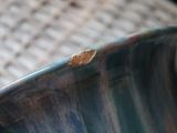 a close up view of a blue vase on a table