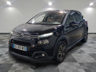 the black citrole is parked in the garage on a checkered floor