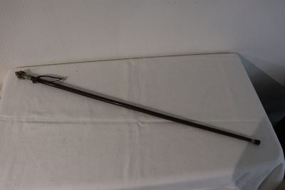 a long stick sitting on top of a white table