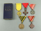 several medals and a book are sitting on a table