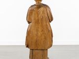 an old wooden statue of a man with a hat on his head