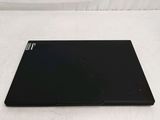 the back of a black laptop computer sitting on top of a white surface