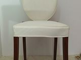 a white chair with a round back in a room