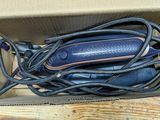 a box with a bunch of cords and a cell phone in it