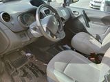 a small yellow car with a steering wheel and dashboard