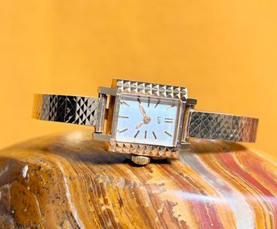a watch that is sitting on top of a rock