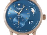 a close up of a wrist watch with a blue dial