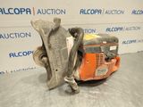 a close up of a chainsaw on a table in front of a wall