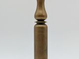 an antique brass candle holder on a wooden base