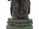 an image of a statue of a man holding a bird on a pedestal