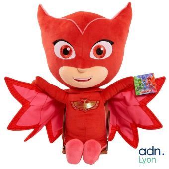 the stuffed animal is wearing a red costume and wings