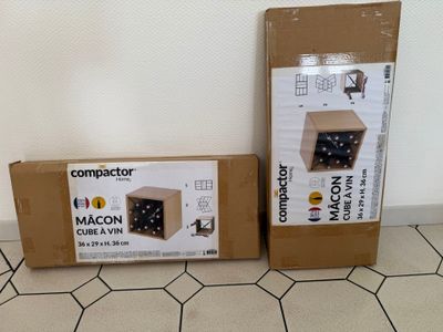 two boxes of wine are sitting on the floor next to each other