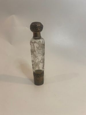 a small glass bottle with a black and white design on it