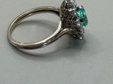 a ring that has a green stone in it