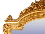 a mirror with a gold frame on a white background