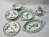 several pieces of blue and white dishes and cups on a table