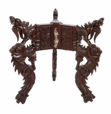 an image of a wooden table with dragon legs and a carved top