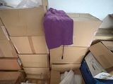 a pile of boxes and a chair in a room