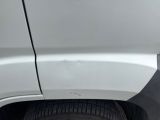 a close up of a white car with a flat tire