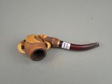 a pipe that is sitting on the ground with a baseball glove on it