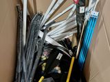 a cardboard box filled with many different types of umbrellas