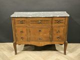 an antique chest of drawers with marble top