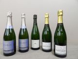 six bottles of champagne are lined up in a row on a table