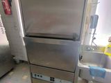a stainless steel refrigerator in a kitchen next to a sink