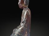 statue of a seated buddha on a black background