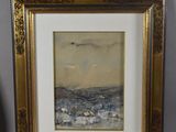 painting of a beach scene in a gold frame next to a vase