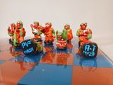 many figurines that are sitting on a chess board