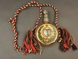 a necklace that has a heart on it with a rope around it