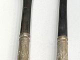 two forks and a spoon sitting next to each other