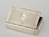 an antique silver box with a monogram on the lid